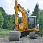 Yellow Bulldozer on mound of gravel